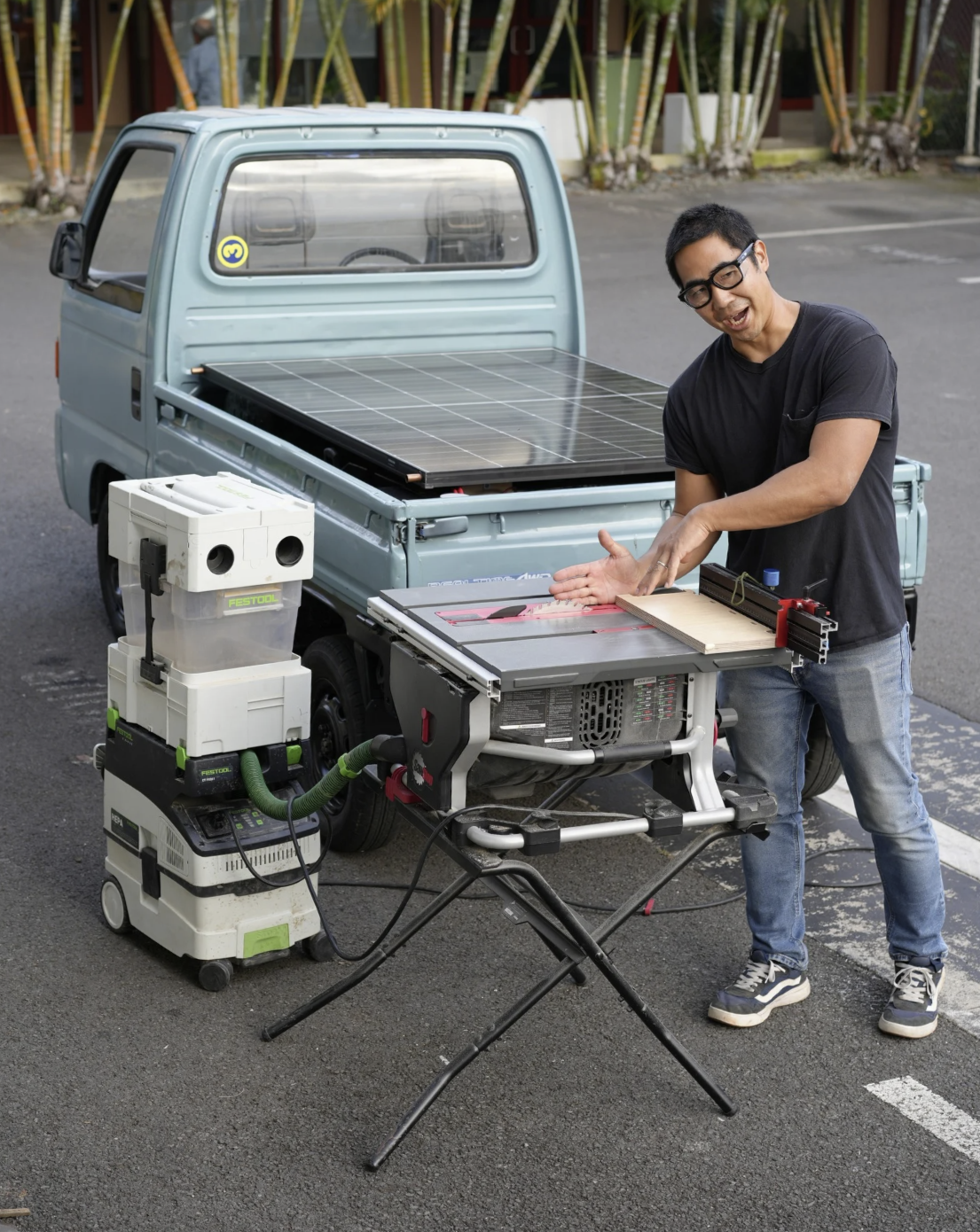 Craftsman working alongside a solar-powered Kei truck